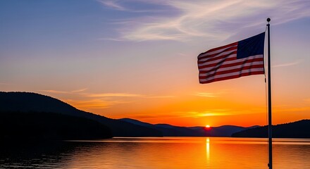 American flag waving in the breeze at sunset with the silhouette of mountains in the background