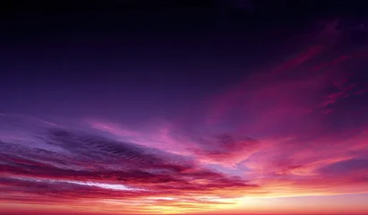Fotobehang Zonsondergang Dramatic sunset cloudscape.  Deep purple and fiery red hues dominate the sky  © Daeng