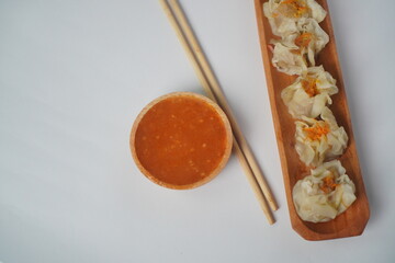 Steamed Shumai Dim Sum on a Wooden Plate	