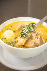 Ecuadorian chicken soup served hot, with rice, potatoes, hard-boiled egg, carrot, onion, celery, and parsley in a deep bowl. A traditional homemade soup, full of Andean flavor and tradition.