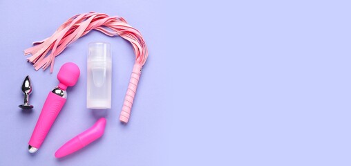 Bottle of lubricant and sex toys on lilac background with space for text, top view