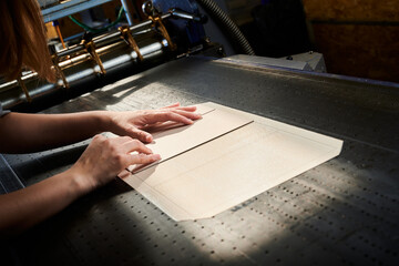 Crafting custom cardboard boxes in a bustling manufacturing plant during the afternoon shift