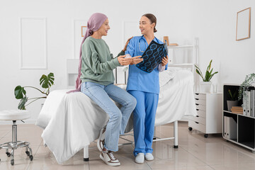 Mature woman after chemotherapy and nurse with MRI scan in hospital room. Brain cancer concept