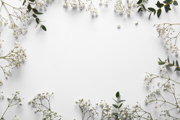 Frame made of beautiful gypsophila flowers on white background