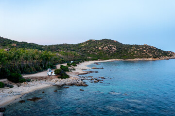 Aerial drone view of camper vans parked near the beach of Capo F