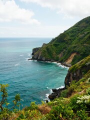 Coastal cliffs overlooking turquoise waters tropical paradise scenic view nature's beauty aerial perspective