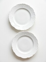 Displaying elegant tableware two white plates on a minimalist surface food presentation clean aesthetic top view dining concept