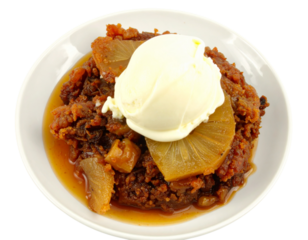 Rich warm fruit pudding with caramelized pineapple slices sweet syrup and a scoop of creamy ice cream.