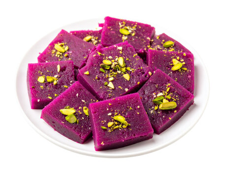 Vibrant purple Kand Halwa a traditional Indian sweet cut into squares and garnished with pistachios.