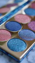 Naklejka premium Close-up of colorful eyeshadow palette on marble surface