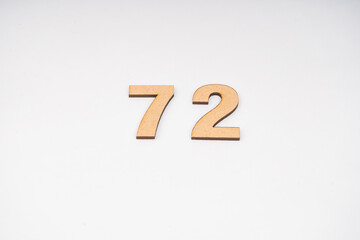 Number seventy-two in paper on a white background.