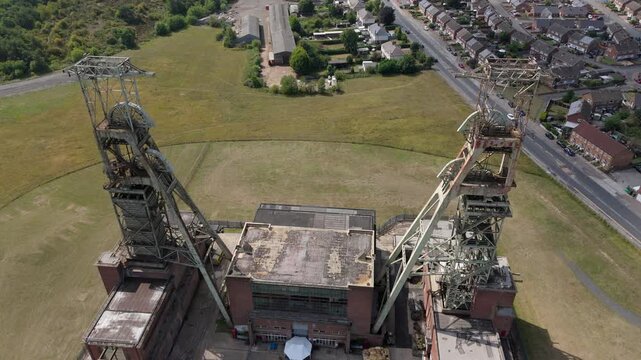 Aerial drone view of coal colliery mine site, industrial revolution legacy infrastructure extracting energy materials from earth Clipstone, Notttingham, England. 