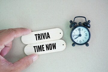 Alarm clock and stick with the words Trivia time now.