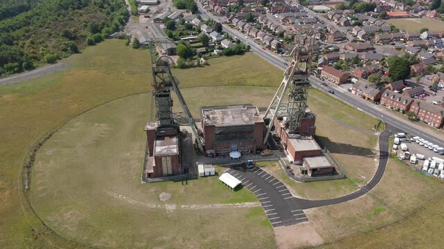 Aerial drone view of coal colliery mine site, industrial revolution legacy infrastructure extracting energy materials from earth Clipstone, Notttingham, England. 