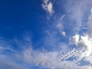 Bright sky with puffy white clouds in the summer sunlight