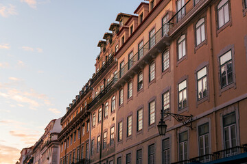 Obraz premium Textured Portuguese tile wall building in downtown Lisbon, Portugal at sunset on a summer day
