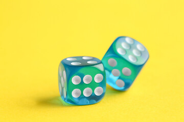 Blue game dices on yellow background