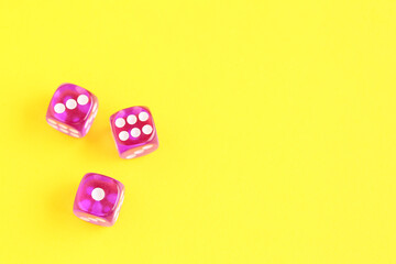 Purple game dices on yellow background
