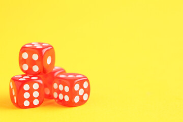 Red game dices on yellow background