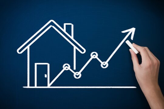 Real estate market growth concept, chalk house and rising arrow on blue board, property investment trend.