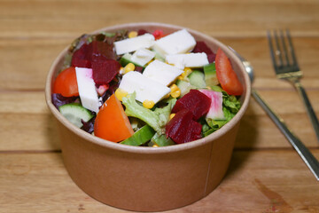 Colorful salad bowl with fresh vegetables and cheese