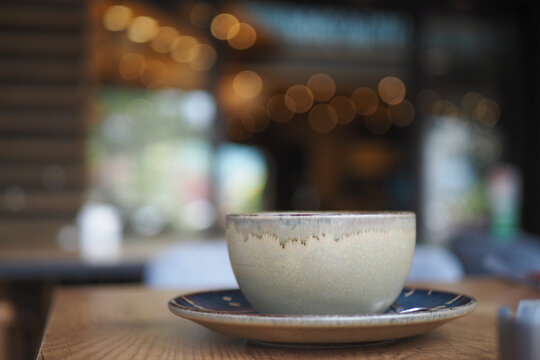 Coffee cup on a wooden table in a cozy cafe setting