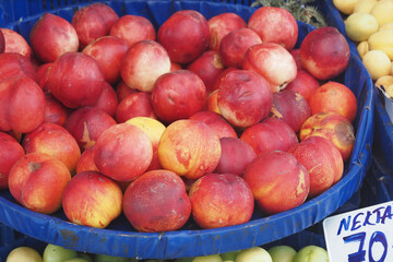 Fresh peaches on display at local market in summer