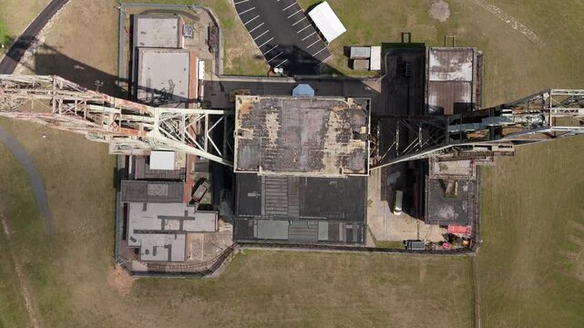 Aerial drone view of coal colliery mine site, industrial revolution legacy infrastructure extracting energy materials from earth Clipstone, Notttingham, England. 
