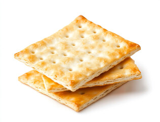 Fototapeta premium A close-up shot of a small pile of square creme crackers stacked against a plain white background. The crackers are golden-brown with small holes on their surface.