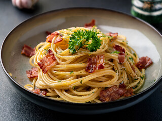 Savory Close-up: Pasta with Crispy Chopped Bacon and Fresh Parsley


