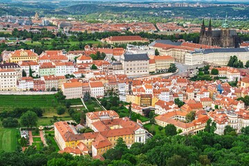 Discover the charm of Prague, Czech Republic, with this aerial view showcasing its iconic red tile roofs and historic architecture. Ideal for travel promotion and exploration.