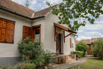 Fototapeta premium View of traditional country house and garden in summer season. 