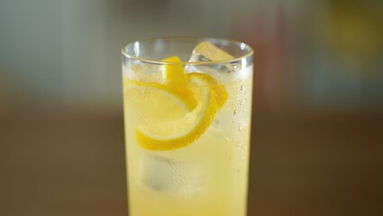 Refreshing Lemonade with Lemon Peel and Ice in Tall Glass
