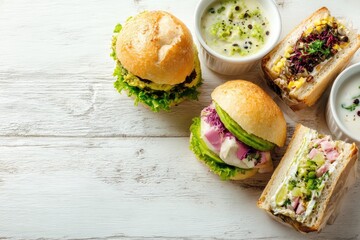 Assorted gourmet sandwiches and soup on a white wooden table