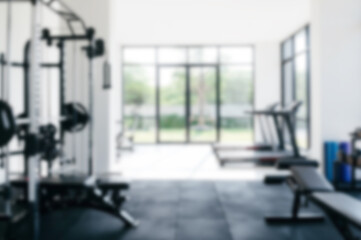Blurred modern gym interior with exercise equipment