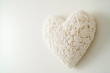 Fototapeta premium Delicate Crochet Heart on White Background, Soft Lighting and Te