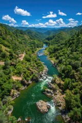 High-angle view of a river winding through a verdant valley. Lush green forests line the mountainsides. 