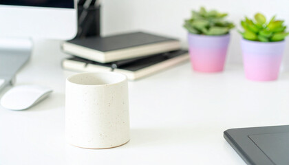 Office Serenity: A minimalistic workspace with a cup, succulent plants, books, a computer monitor, and a mouse, exuding a calm and productive atmosphere.