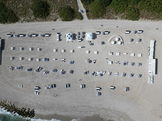 Aerial top view of sand beach with sunbed and umbrella. Summer vacation. Beach vacation at sea in...