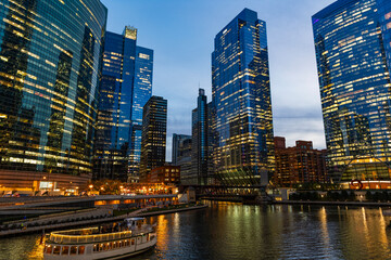 Fototapeta premium Skyscraper architecture. Chicago city cityscape. Cityscape night with skyscraper building. Skyline architecture. Chicago city with illuminated building. Night Chicago city downtown. Night city mood