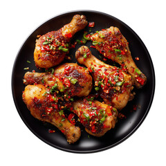 chicken drumsticks marinated in chili, top view, on black plate, on white background
