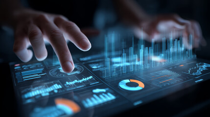 Futuristic digital tablet with holographic data charts and graphs being manipulated by hands dark environment showing advanced technology