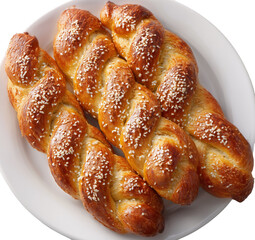 long, braided, sweet breads with sesame seeds on top, on a white plate, top view, close-up, food photography
