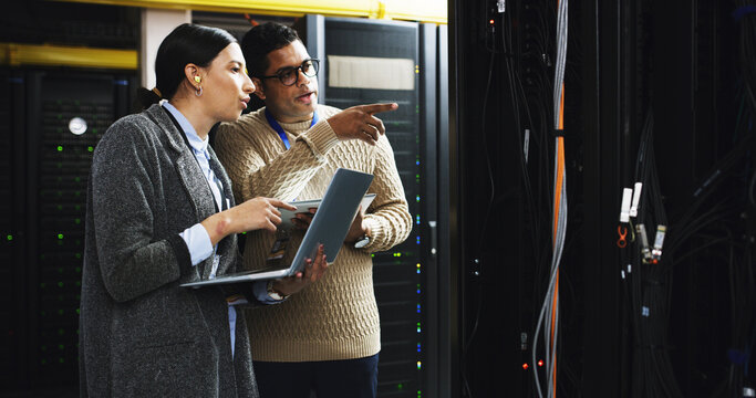 Datacenter, team and people with laptop for maintenance, software update or system inspection. Server room, collaboration or cloud computing with IT engineer for database, cybersecurity or discussion