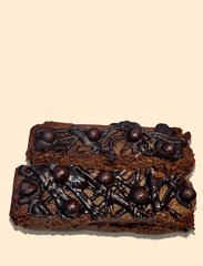 Chocolate brownies with chocolate balls topping on beige background. National Brownie Day to celebrate on December 8th