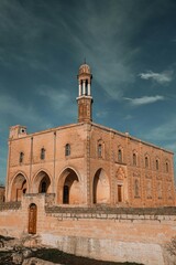 Obraz premium Captivating view of an ancient monastery featuring remarkable stone architecture and a tall, elegant tower, reflecting the rich history and spiritual depth of the region.