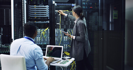 Woman, tablet and cables with inspection in server room, man or assessment for IT solution at company. People, programming and hardware with tech, app or information technology for diagnostics test