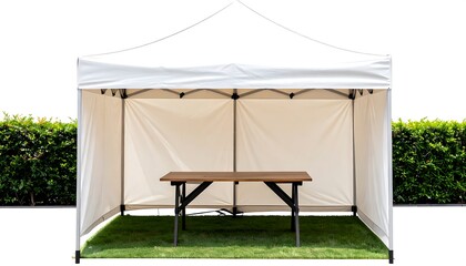 White canopy tent with folding table on grassy area, flanked by hedges