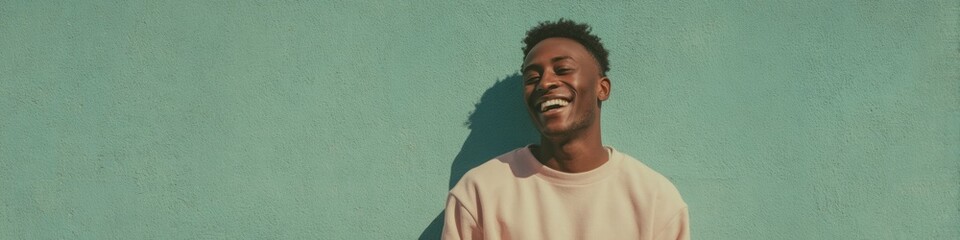 Obraz premium Authentic Young African American Man Laughing with Confidence Outdoor Urban Wall Premium Lifestyle Content for Social Media Marketing Campaigns