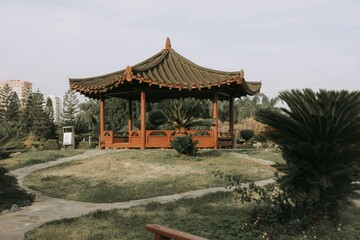 A serene view of an Asian-style pavilion with a traditional design in a peaceful garden setting
